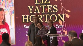 Horton accepts her award on stage at the 20th WISE womens business center symposium.