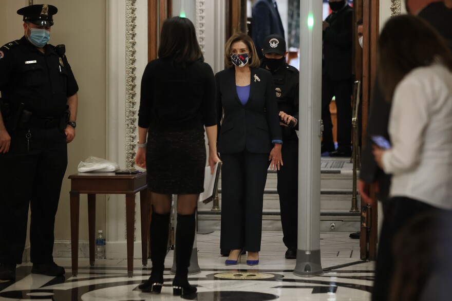 Speaker of the House Nancy Pelosi, D-Calif., is screened at a metal detector at the doors of the House of Representatives Chamber on Tuesday.