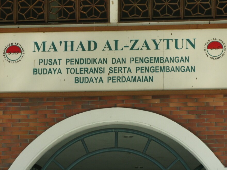 The motto on a sign above the school's door emphasizes "toleransi" or tolerance toward people of other ethnic and religious groups.
