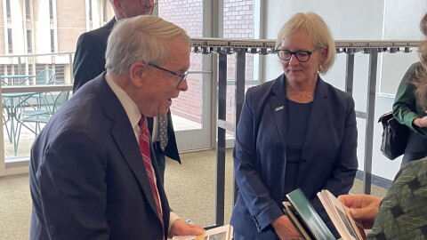 Ohio Governor Mike DeWine, left, receives notecards designed by students from Cleveland State University President Laura Bloomberg after her State of the University speech on Oct. 14.