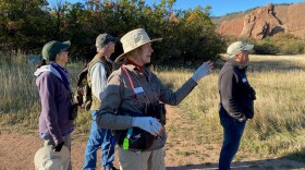 Bea Weaver (center) points out a bird on the group's hike through Roxborough State Park.