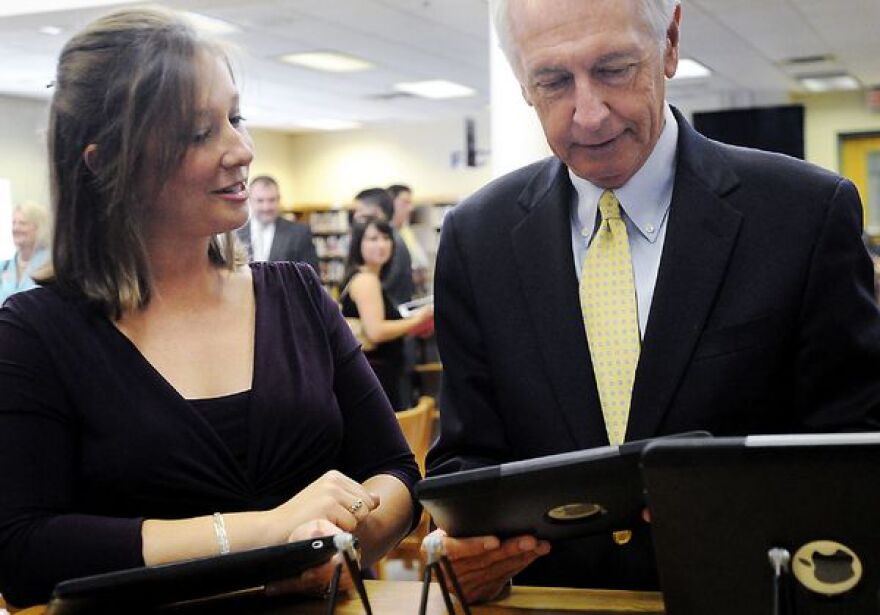 Becky Keith shows Gov. Steve Beshear how she used the iPad in her Spanish class last year during the launch for Kentucky on iTunes U at Woodford County High School Wednesday morning.