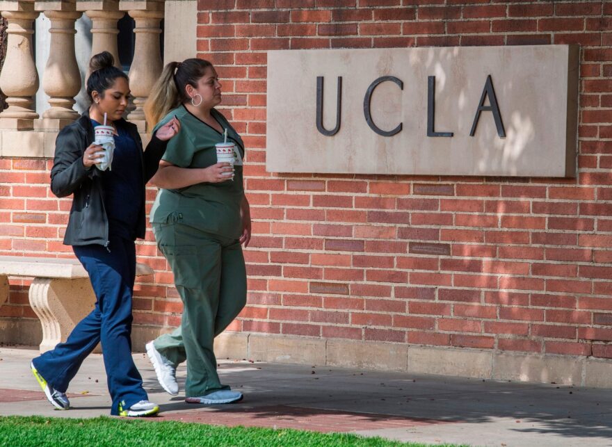 People walk through the campus of the UCLA college in Westwood, California. The UC system has announced that they will phase out the use of the SAT and ACT in their admissions process. 