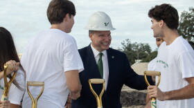 USF President Moez Limayem smiles with students at a groundbreaking ceremony for Uptown Landing. 