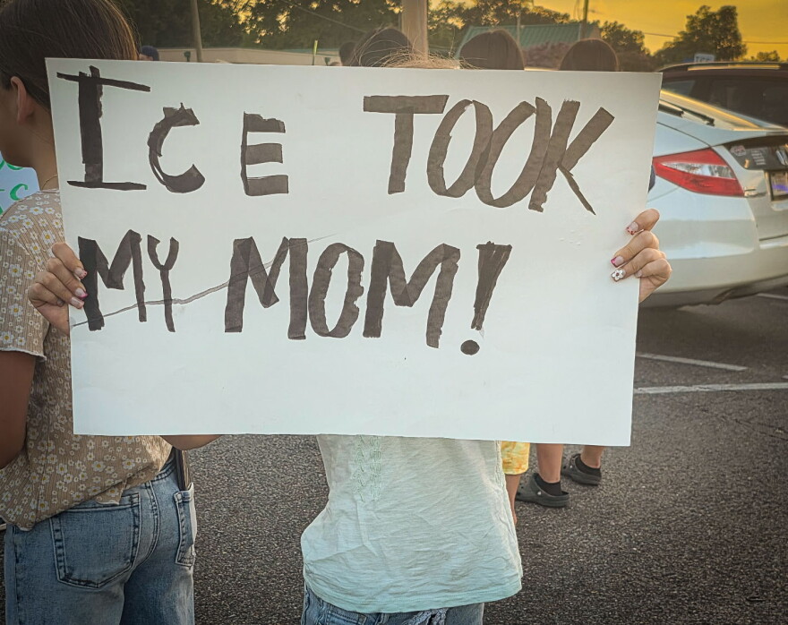 A child protests the ICE arrest of 121 people from a restaurant in Memphis on Aug. 31.