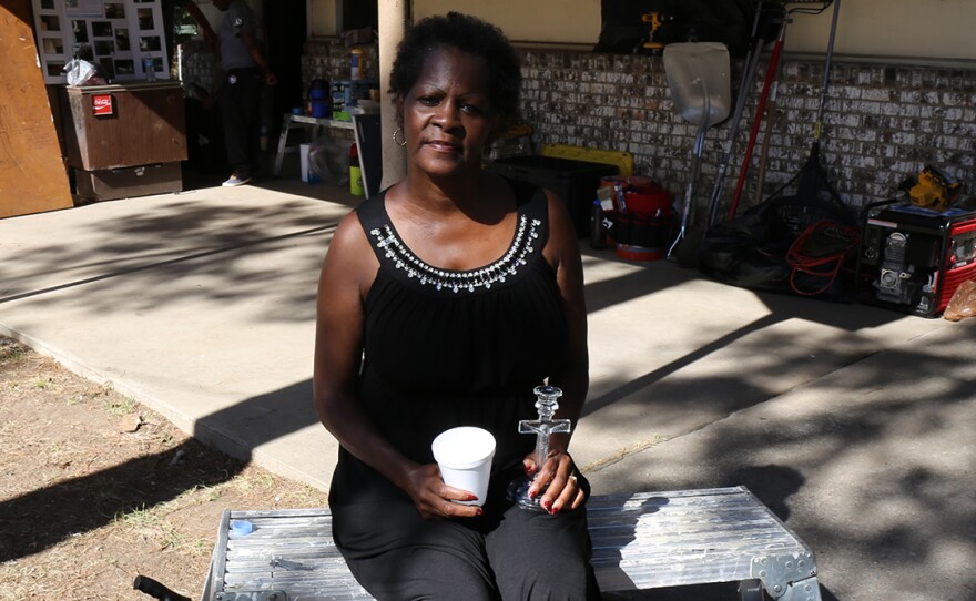 Lou Alice James is the 200th homeowner to receive assistance from the Midlands Flood Recovery Group. Here, she clings to the one family heirloom that survived the mold, a crystal candlestick.