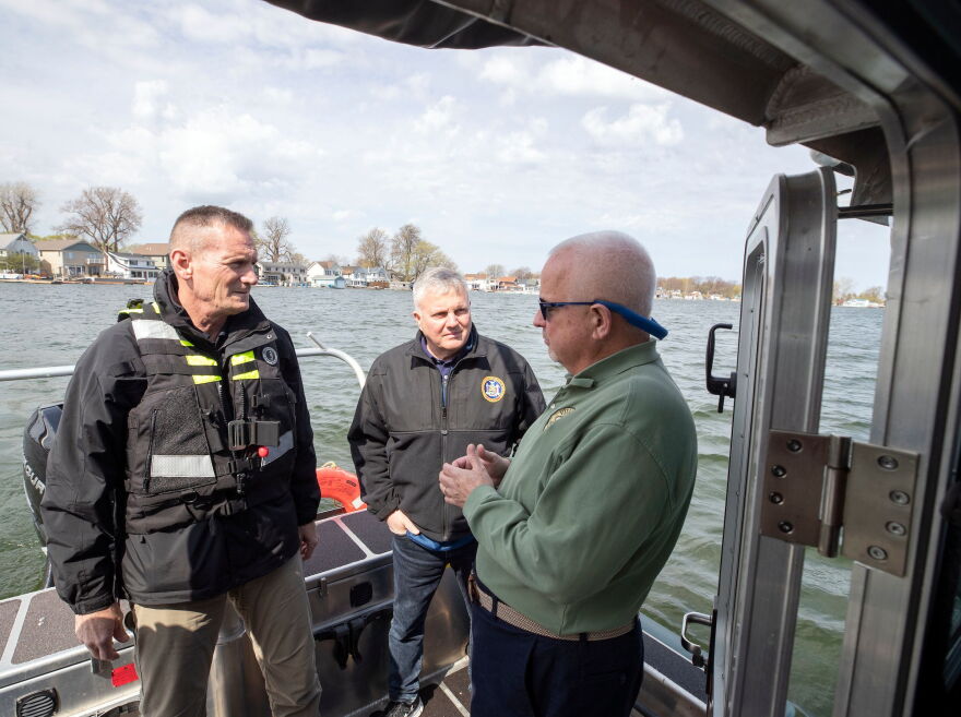 Officials survey lake levels in Sodus Point on Thursday.