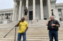 Nimrod Chapel, President of the Missouri NAACP (left), addresses a rally on the steps of the Capitol Building, flanked by a sign language interpreter. 