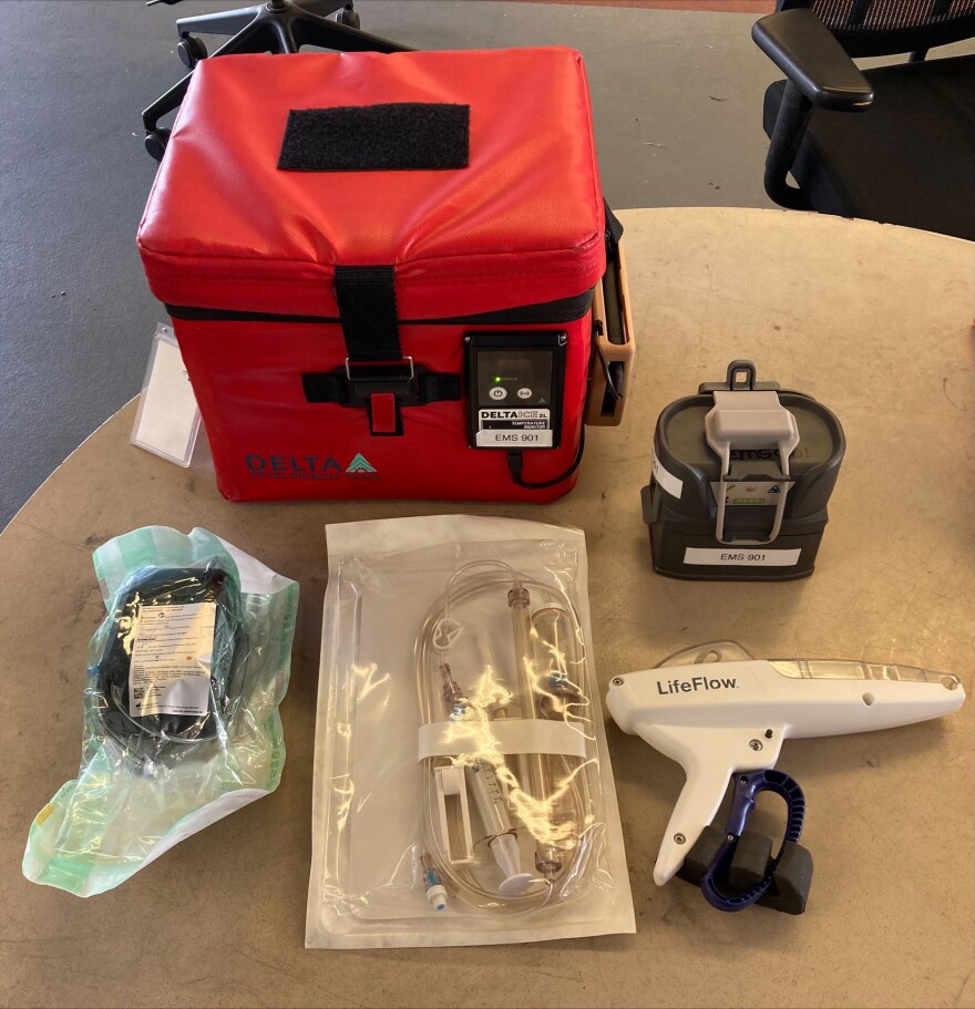 Equipment used for administering whole blood transfusions, including the storage unit, cooling unit, battery pack, tubing and hand pump.
