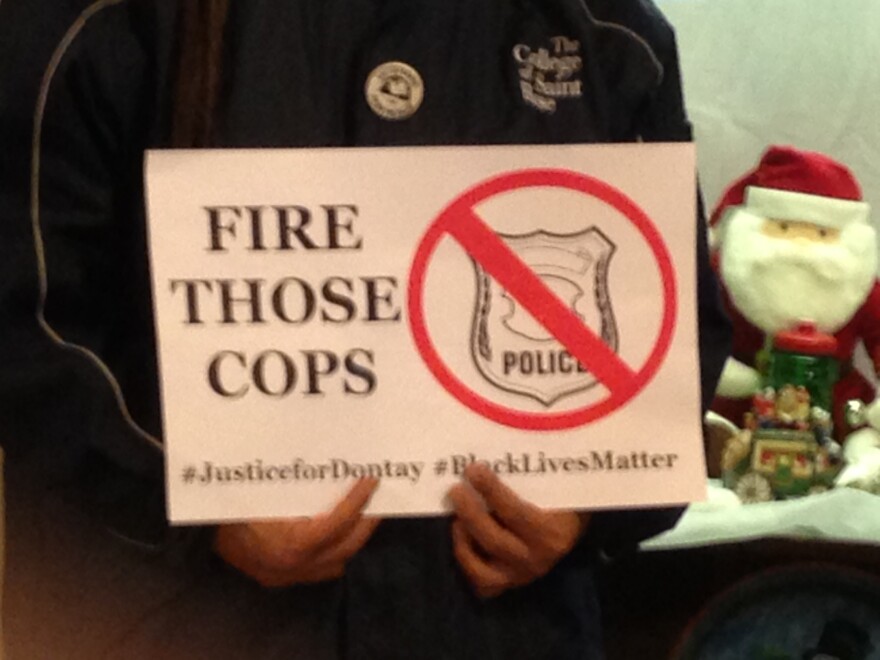 "Fire Those Cops" poster carried by activist.