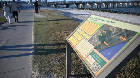 A sign reading "Healthy Water, Healthy Community" sits next to a hike and bike path in Cole Park in Corpus Christi on March 19, 2026.