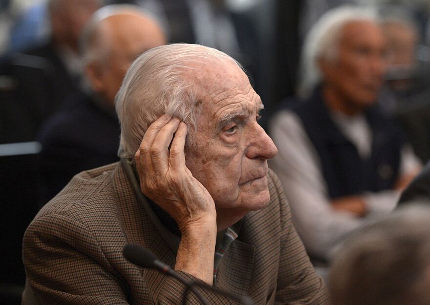 Former general and member of the military junta, Reynaldo Bignone, gestures during his trial to investigate the crimes committed during the Operation Condor in March 2013.