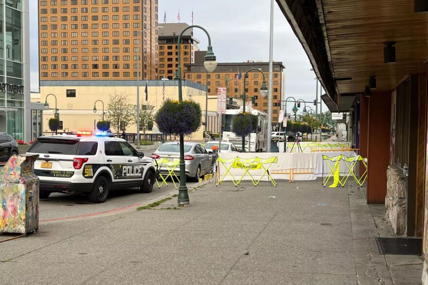 Police barricades and evidence markers outside a bar