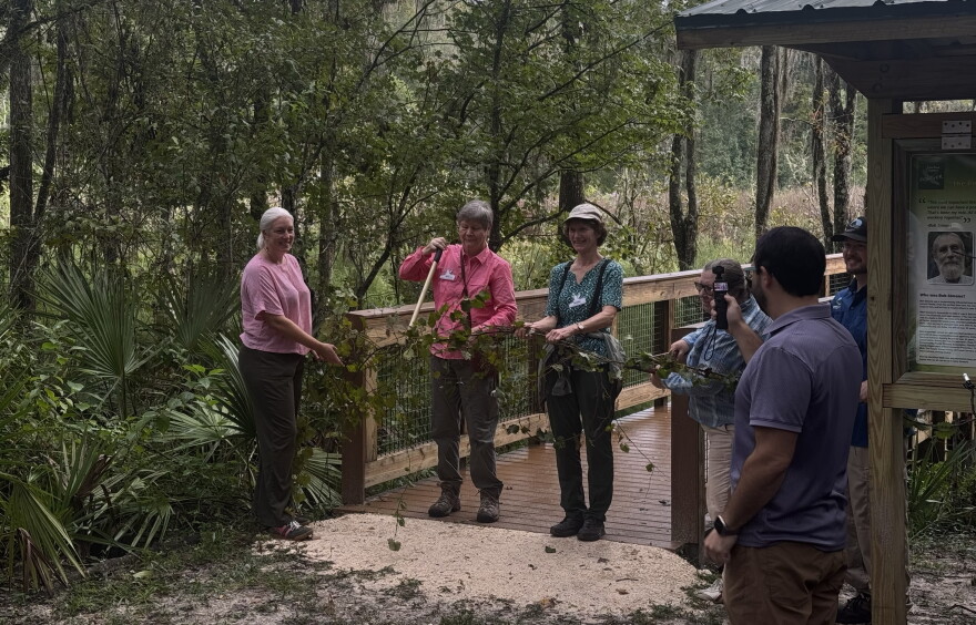 The three speakers, and Bob Simons’ widow, Erika Simons, ceremoniously cut the vine to open the observational platform on Saturday, Oct. 3, 2026. (Arjun Mendiratta/WUFT News)