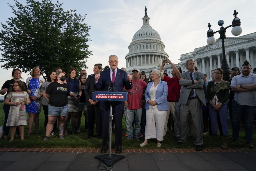 Senate Majority Leader Chuck Schumer of N.Y., center, speaks alongside veterans, military family members and advocates at a news conference after the Senate passed a bill designed to help millions of veterans exposed to toxic substances during their military service, Tuesday, Aug. 2, 2022, on Capitol Hill in Washington.