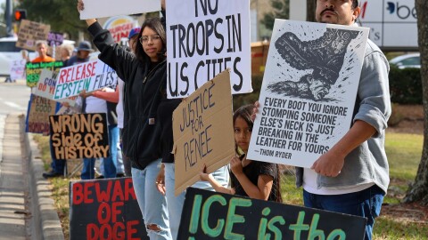 Alvaro Nicaragua, 37, and his daughter Alana Nicaragua, 6, protest with members of their family on Newberry Road in Gainesville, Florida, on Saturday, Jan. 24, 2026.