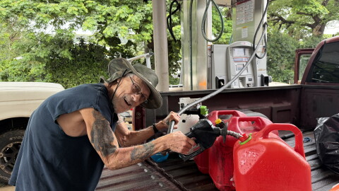 Nāʻālehu resident Joe Steele fills up gas cans at the townʻs gas station on the afternoon of Friday, Sept. 25, 2026, in preparation for Hurricane Nolo.