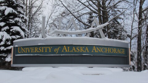 A sign says University of Alaska Anchorage in the snow
