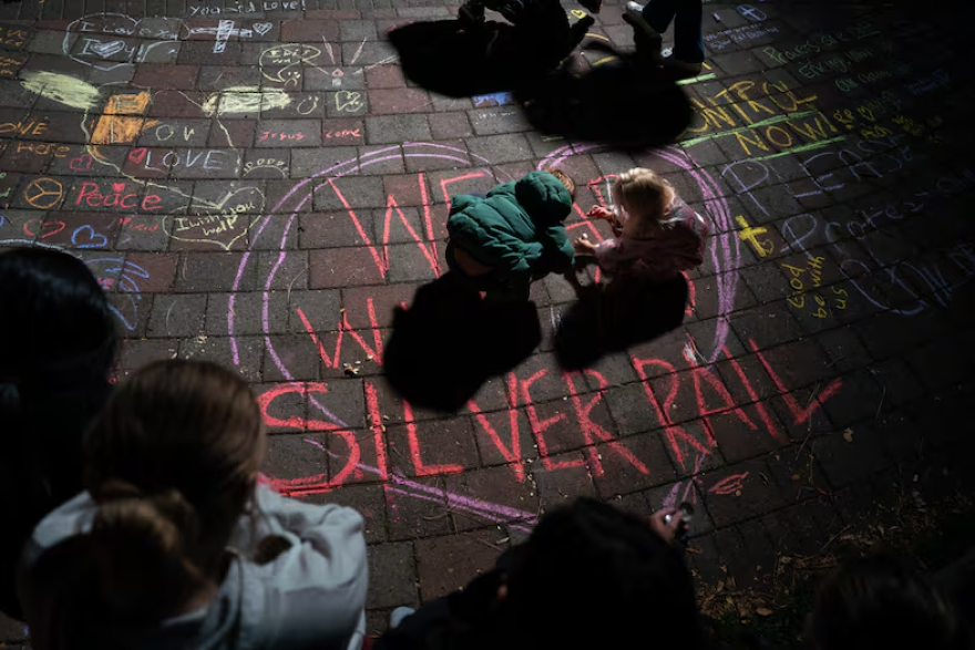 Children draw with chalk.