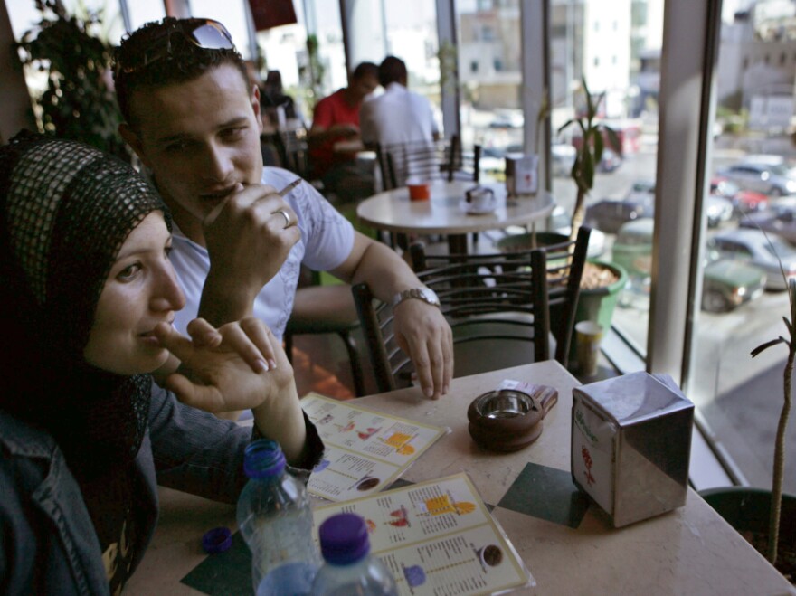 Nidaa Al-Barghothy (left) and her brother  Mohammad Al-Barghothy  sit at a coffee shop in Ramallah, the political and commercial capital of the West Bank, in 2007.