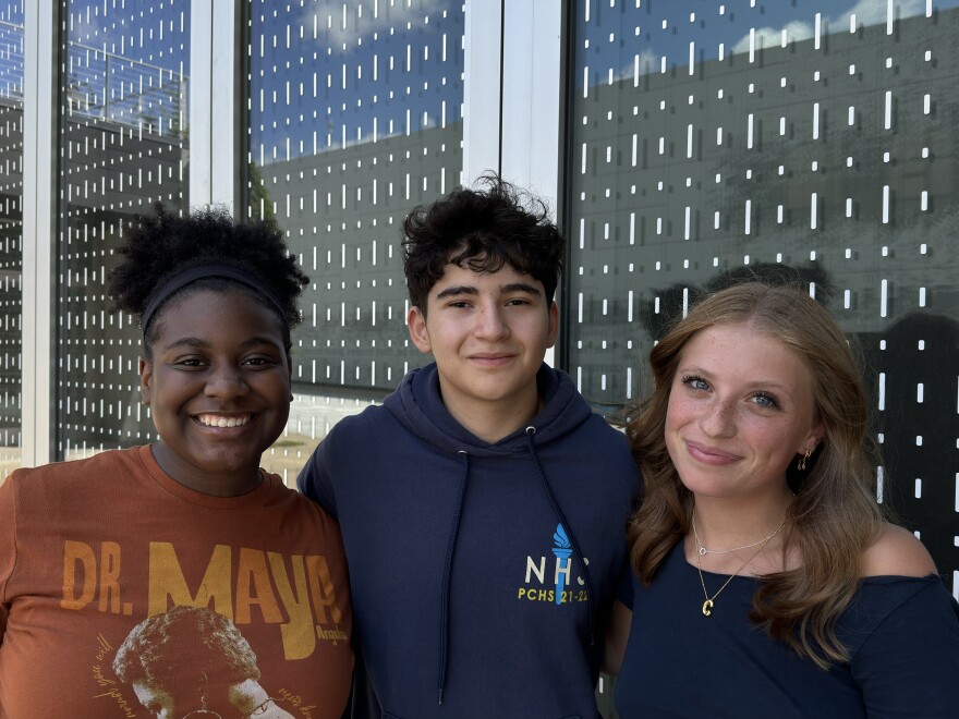 Aylah Hopper, Diego Perez Palomino and Charlie Meyers pose for a photo outside of St. Louis Public Radio on August 2, 2024.