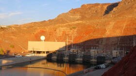 a canal runs into a red rock mountain