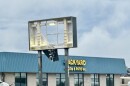 Storm damage at a business, on its sign, exterior to the building