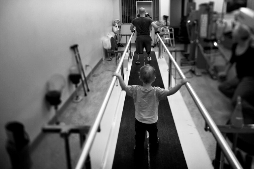 Liam, 2, accompanies his dad, Jake Romo, during rehab at the Naval Medical Center in San Diego. Romo, 22, lost both his legs while serving with the 3rd Battalion, 5th Marines, in Sangin, Afghanistan. From the story "<a href="https://www.npr.org/2011/11/04/141988965/for-wounded-marines-the-long-hard-road-of-rehab" target="_blank">For Wounded Marines, The Long, Hard Road Of Rehab</a>," 2011.