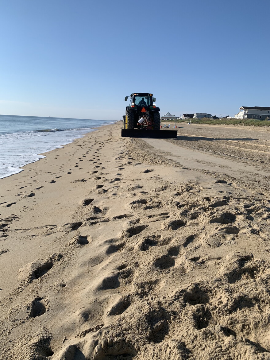 A tractor carries out beach maintenance in Sandbridge in Virginia Beach.