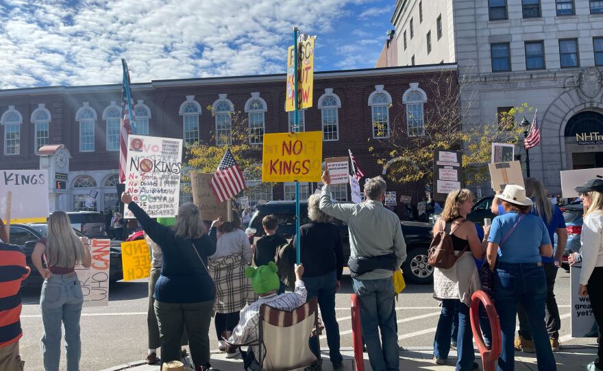 Protesters hold signs and chant along Main St. in Concord at a No Kings rally in opposition to the Trump administration on Oct. 18, 2025.