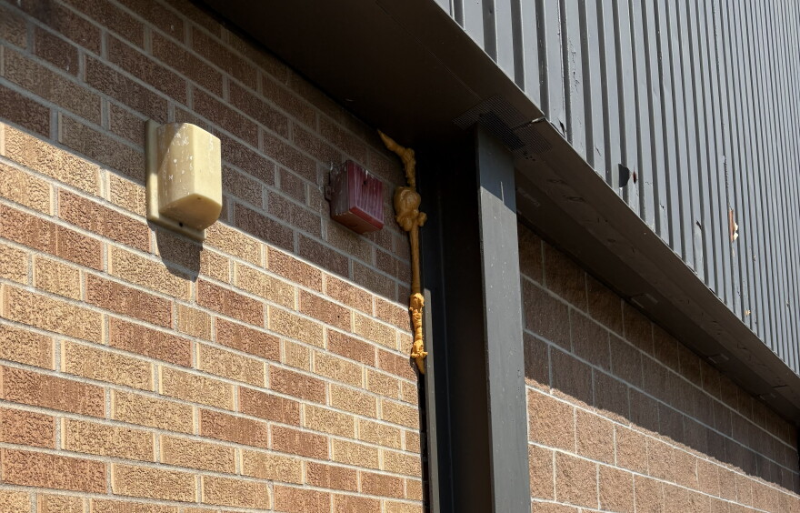 A crack in the building's exterior has been temporarily filled.
