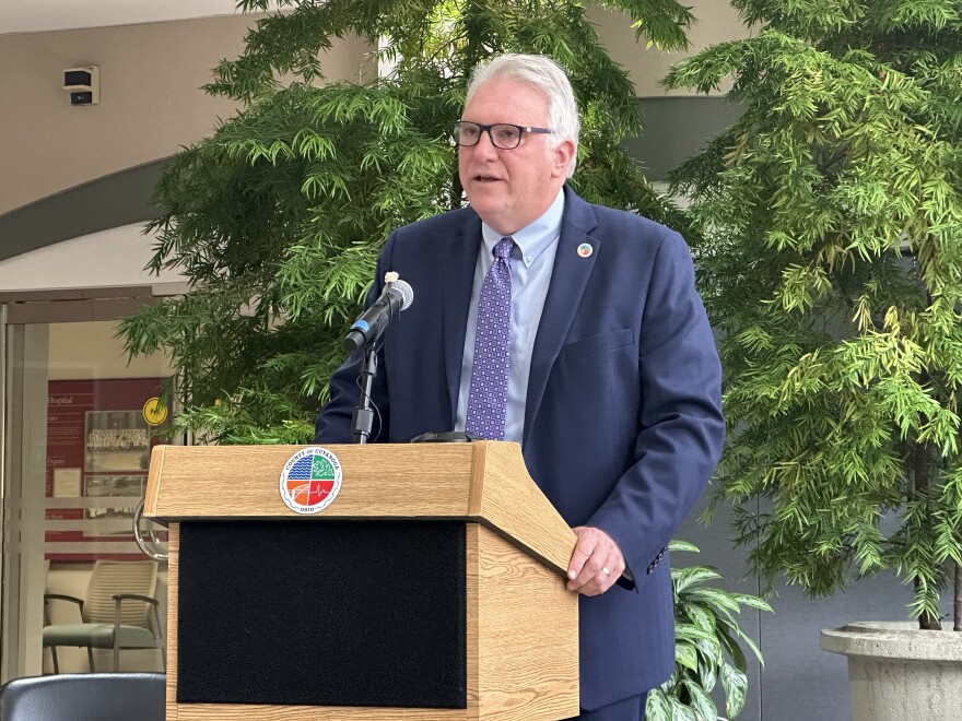 Cuyahoga County Executive Chris Ronayne speaks from a podium inside the atrium at MetroHealth Medical Center in Cleveland on Sept. 26, 2023.