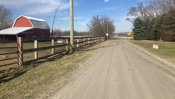 Early spring view of Ostrander homestead on the left