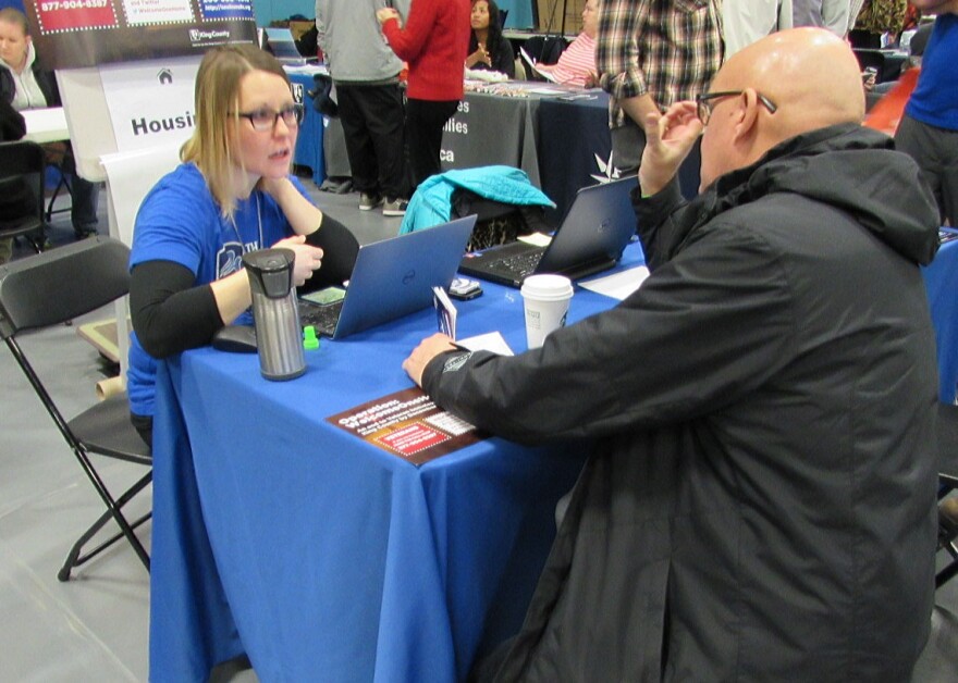 Dawn Barrett works with a veteran inquiring about housing at the Seattle Stand Down.