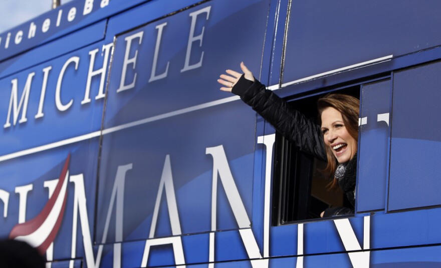 Republican presidential candidate Michele Bachmann waves from her bus after a campaign stop at Valley High School on Tuesday in West Des Moines, Iowa.