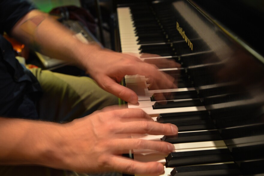 Mark Lowrey's hands flow over the keys of his Baldwin piano Wednesday (April 15) during the evening dining hours at Cafe Trio.