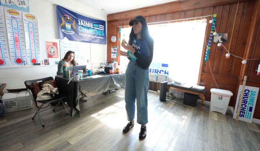 Democratic state Rep. Jaime Churches looks over her phone before going door to door to campaign, Friday, Oct. 11, 2024, in Trenton, Mich.