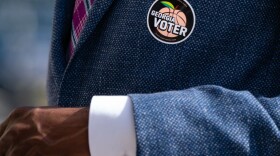 A "Georgia Voter" sticker is seen on the jacket of Democratic U.S. Senate candidate Raphael Warnock after he cast his ballot during early voting on October 21, 2020 in Atlanta, Georgia. (Elijah Nouvelage/Getty Images)