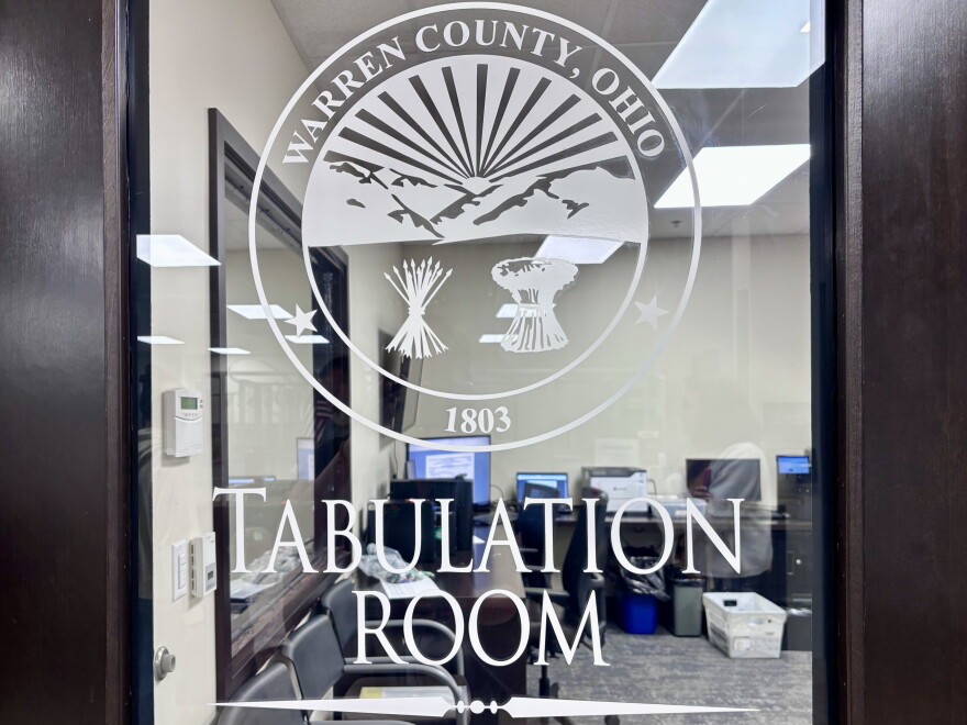 A brown door with a clear glass panel in the middle bears the seal for the Warren County Board of Elections and the words, "Tabulation Room."