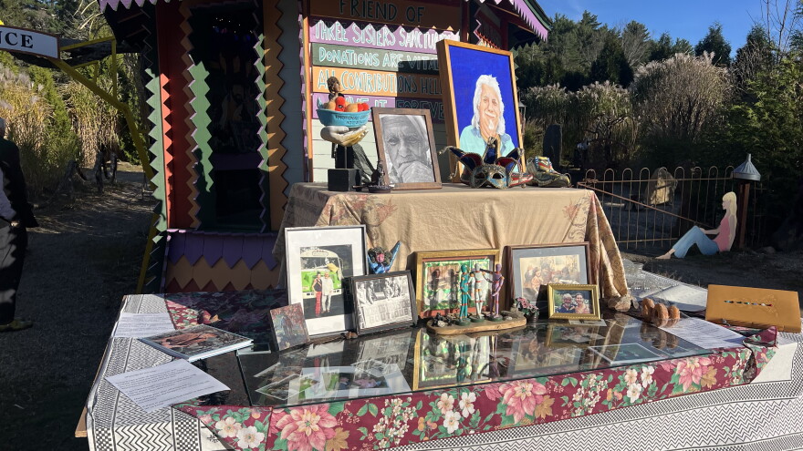 A table filled with tributes to Richard M. Richardson, creator of the "Three Sisters Sanctuary" in Goshen, Mass.