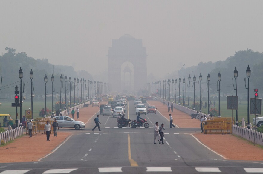 India Gate, a central Delhi landmark, is barely visible through thick smog in early November. The city's air quality has hit new lows recently.