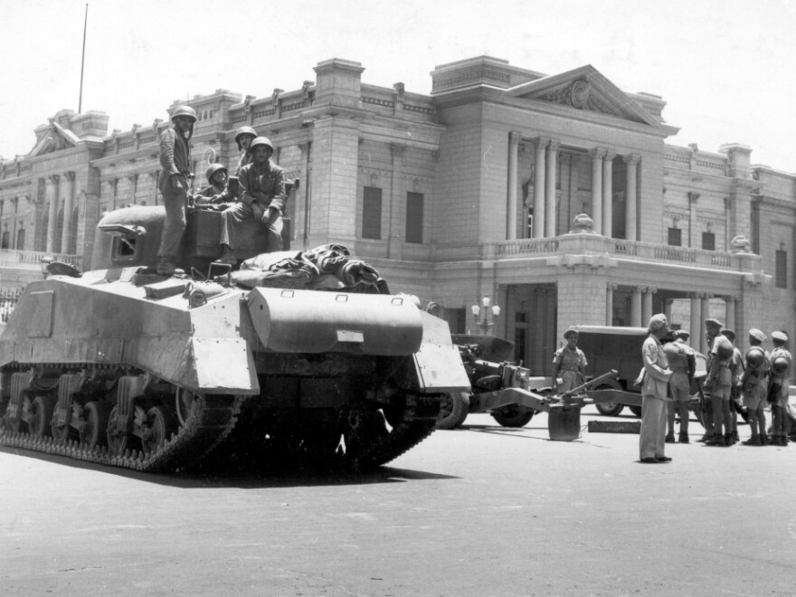 During a coup d'etat led by General Muhammed Naguib,  Egyptian army tanks and field guns are drawn up in front of the royal  Abdin Palace, in Cairo, on July 26, 1952. Appointed Premier Ali  Maher Pasha issued an ultimatum to King Farouk I, forcing the Egyptian monarch  to abdicate.