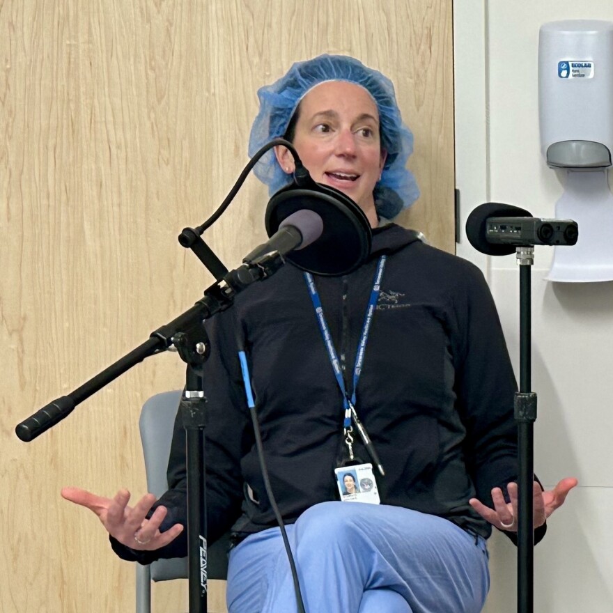 Dr. Kristen Scarpato records an interview in scrubs, having just left a surgery.