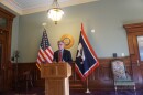 Governor Gordon speaks at podium flanked by the US flag and Wyoming flag