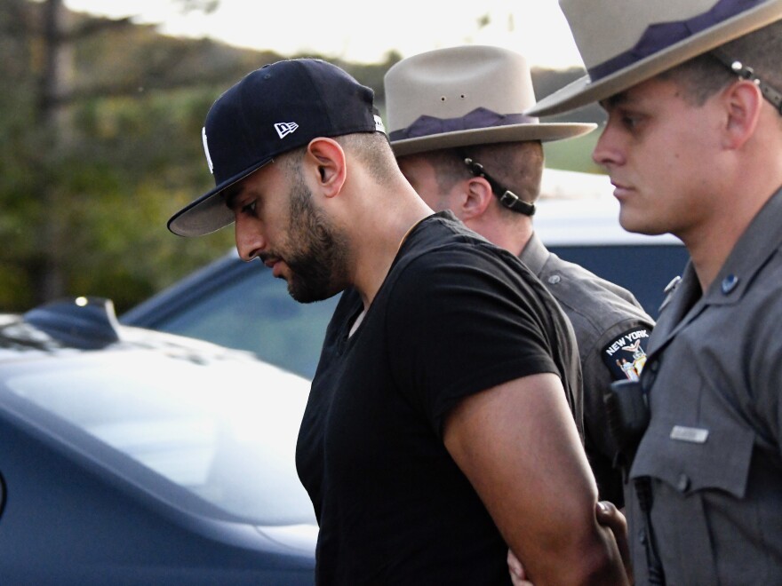 Nauman Hussain is brought into Cobleskill Town, N.Y., court for arraignment Wednesday.