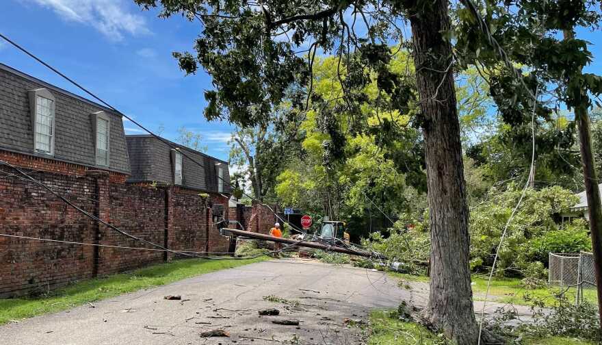 Baton Rouge city workers remove a utility pole knocked down by Hurricane Ida’s winds in the Baton Rouge Garden District. August 30, 2021.