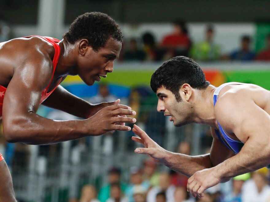 A photo from 2016 Rio Games, shows Iran's Ali Reza Karimi, right, facing off USA's J'den Michael Tbory Cox (red) in the men's 86kg freestyle quarter-final match.