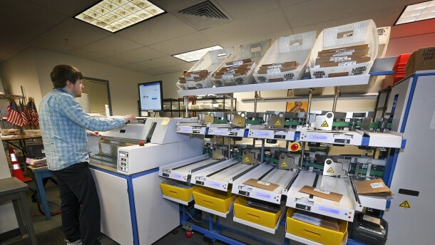 Ryan Patraw process ballots at the Marion County Clerk’s Office in Salem on Monday, May 16. Each ballot goes through several steps before it is scanned to have the vote tabulated.