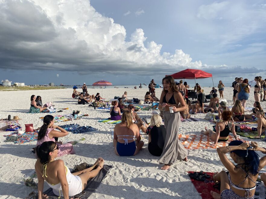 Group of women sitting on a beach