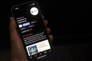 A person holding a phone with The Louisville Free Public Library's app Libby on the screen